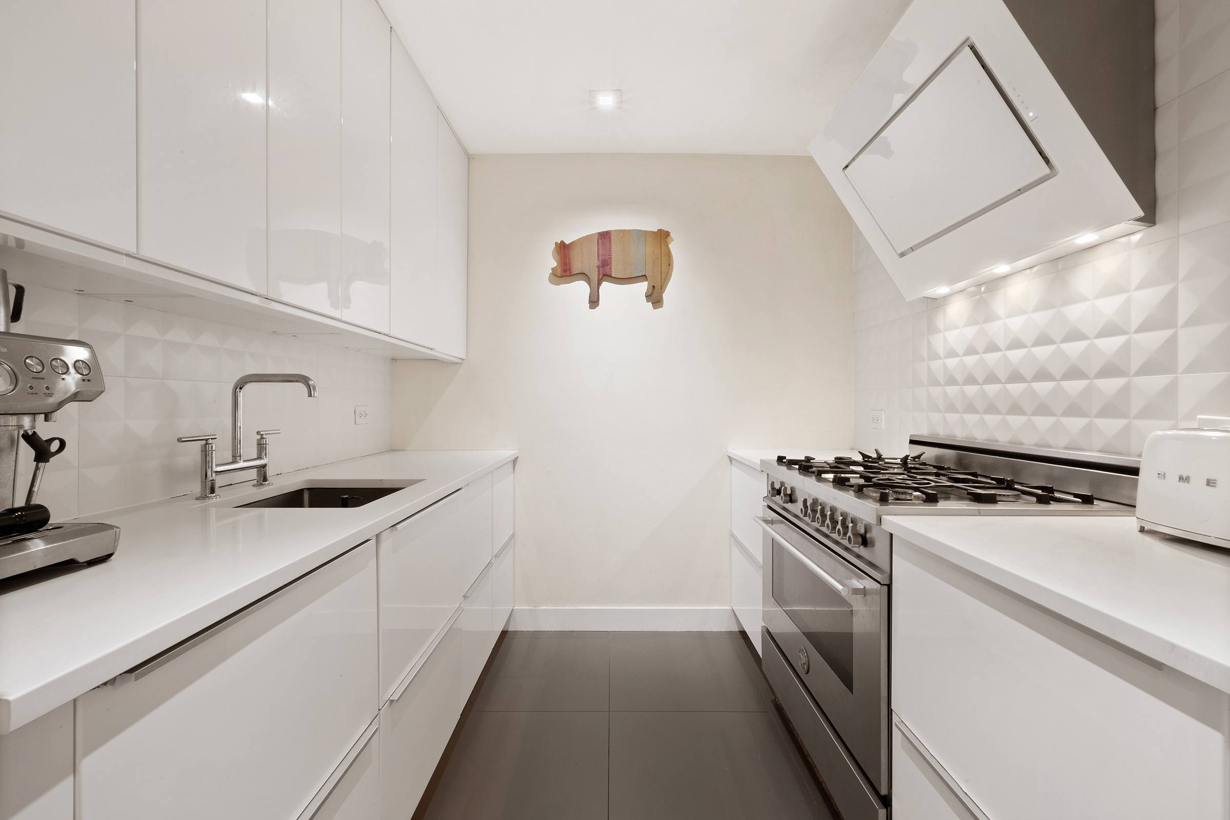 138 North 3rd Street, Unit 1 Brooklyn, NY 11249 - Photo 6 of 8 a kitchen with stainless steel appliances a sink stove and cabinets
