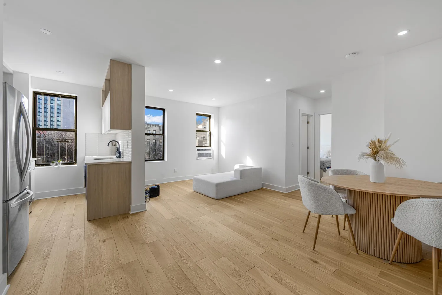 a living room with furniture and a wooden floor