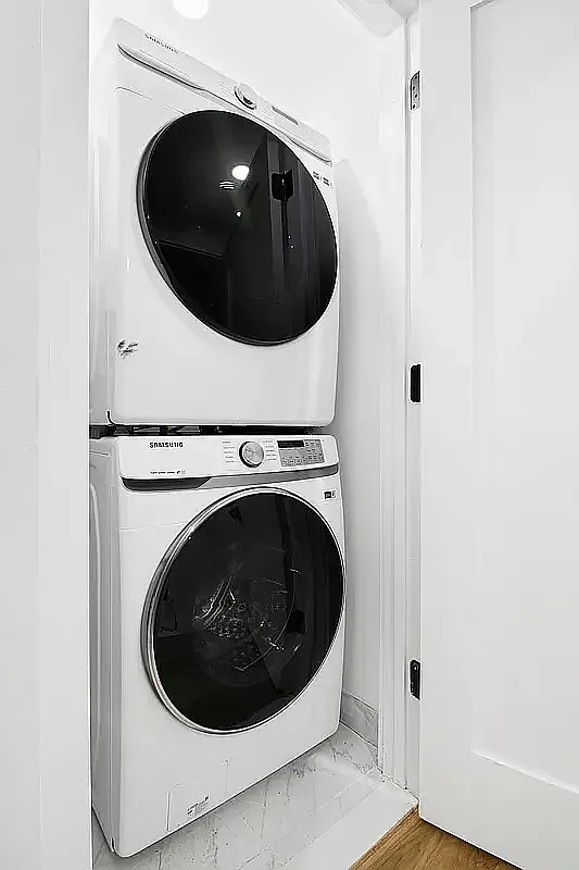 587 Van Buren Street, Unit 1 Brooklyn, NY 11221 - Photo 6 of 8 a utility room with dryer and washer
