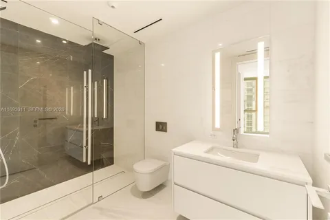 a bathroom with a bathtub shower sink and toilet