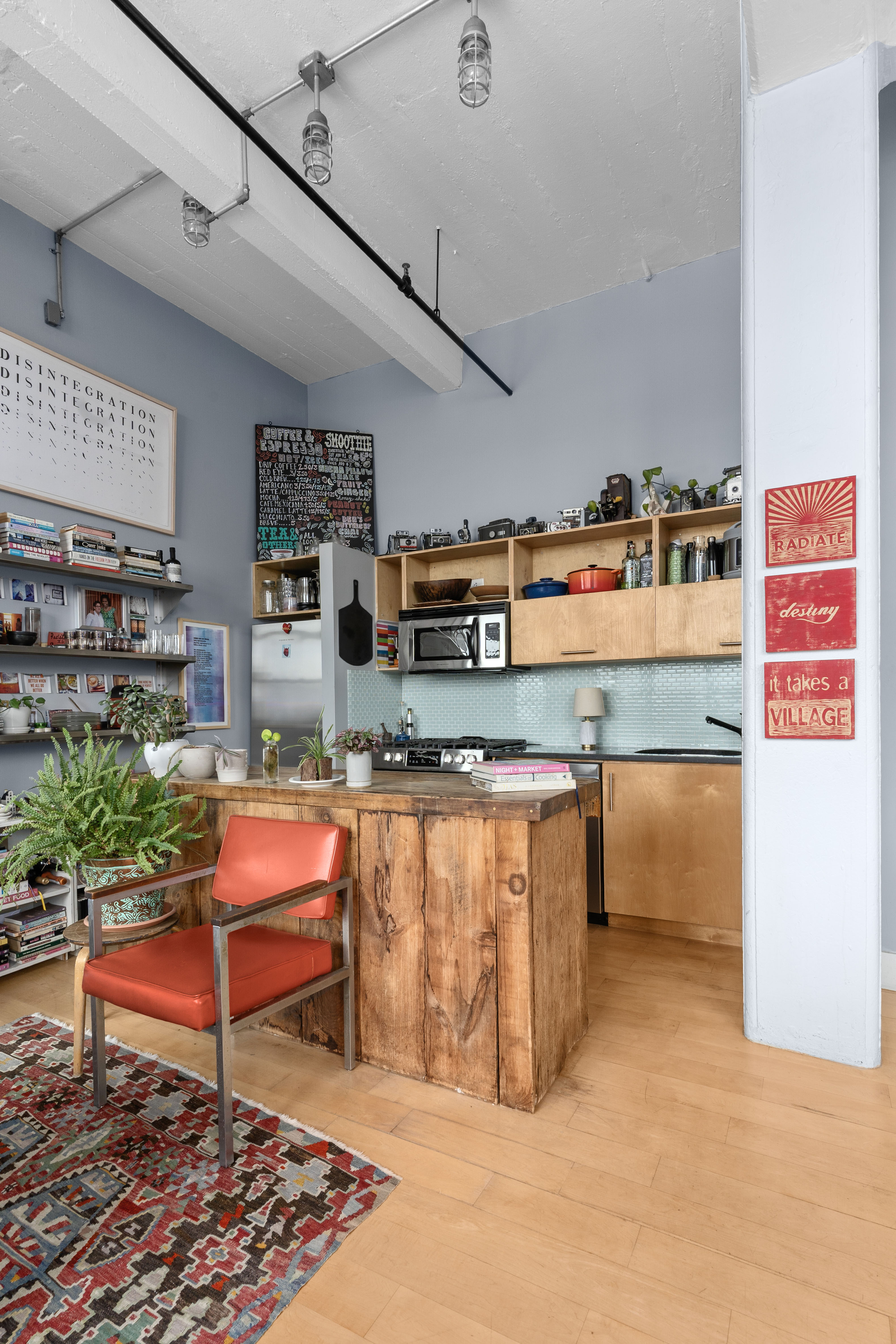 970 Kent Avenue, Unit 513 Brooklyn, NY 11205 - Photo 2 of 8 a room with stainless steel appliances kitchen island granite countertop a table and chairs in it