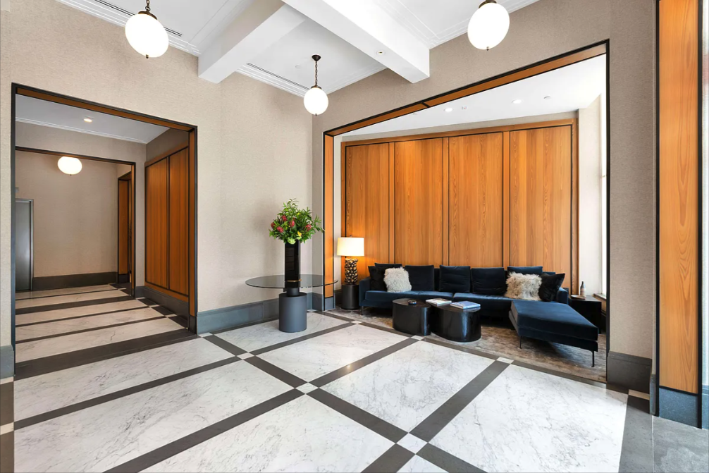 10 Madison Square West, Unit 9G Manhattan, NY 10010 - Photo 9 of 13 a living room with furniture and a large window