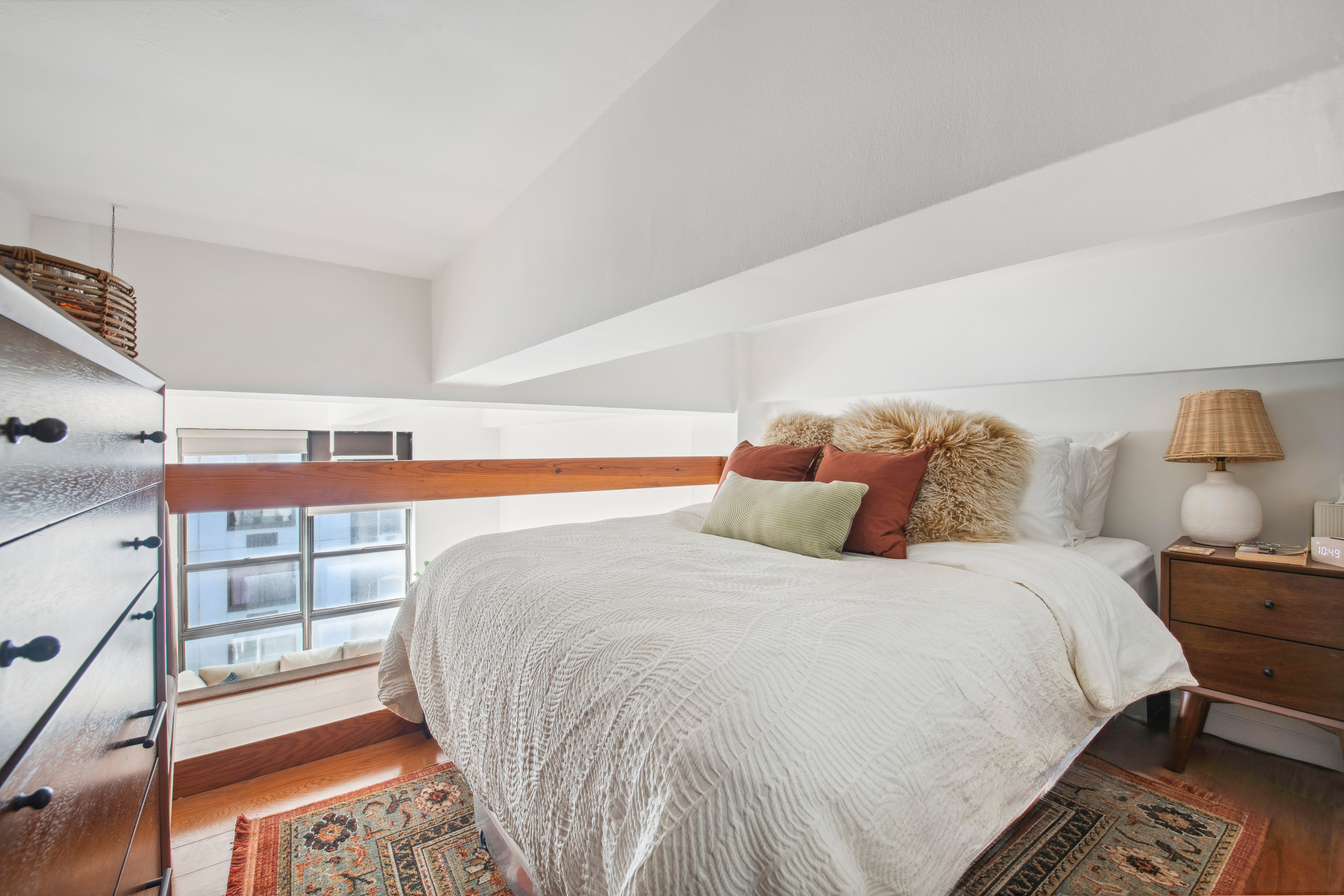 350 East 62nd Street, Unit 3J Manhattan, NY 10065 - Photo 6 of 9 a large bed sitting in a bedroom next to a window