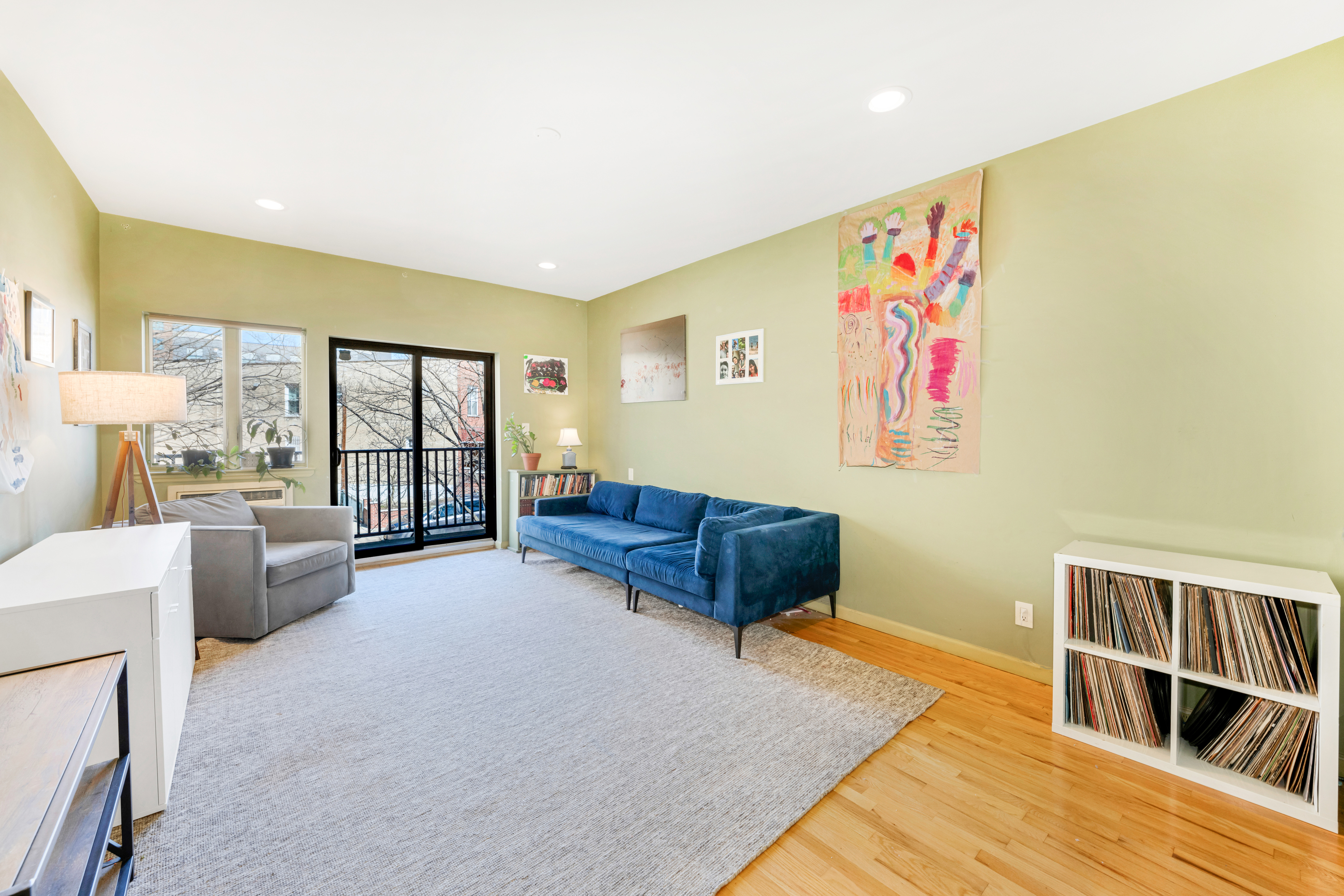 2356 61st Street, Unit 1B Brooklyn, NY 11204 - Photo 1 of 10 a living room with furniture and a floor to ceiling window
