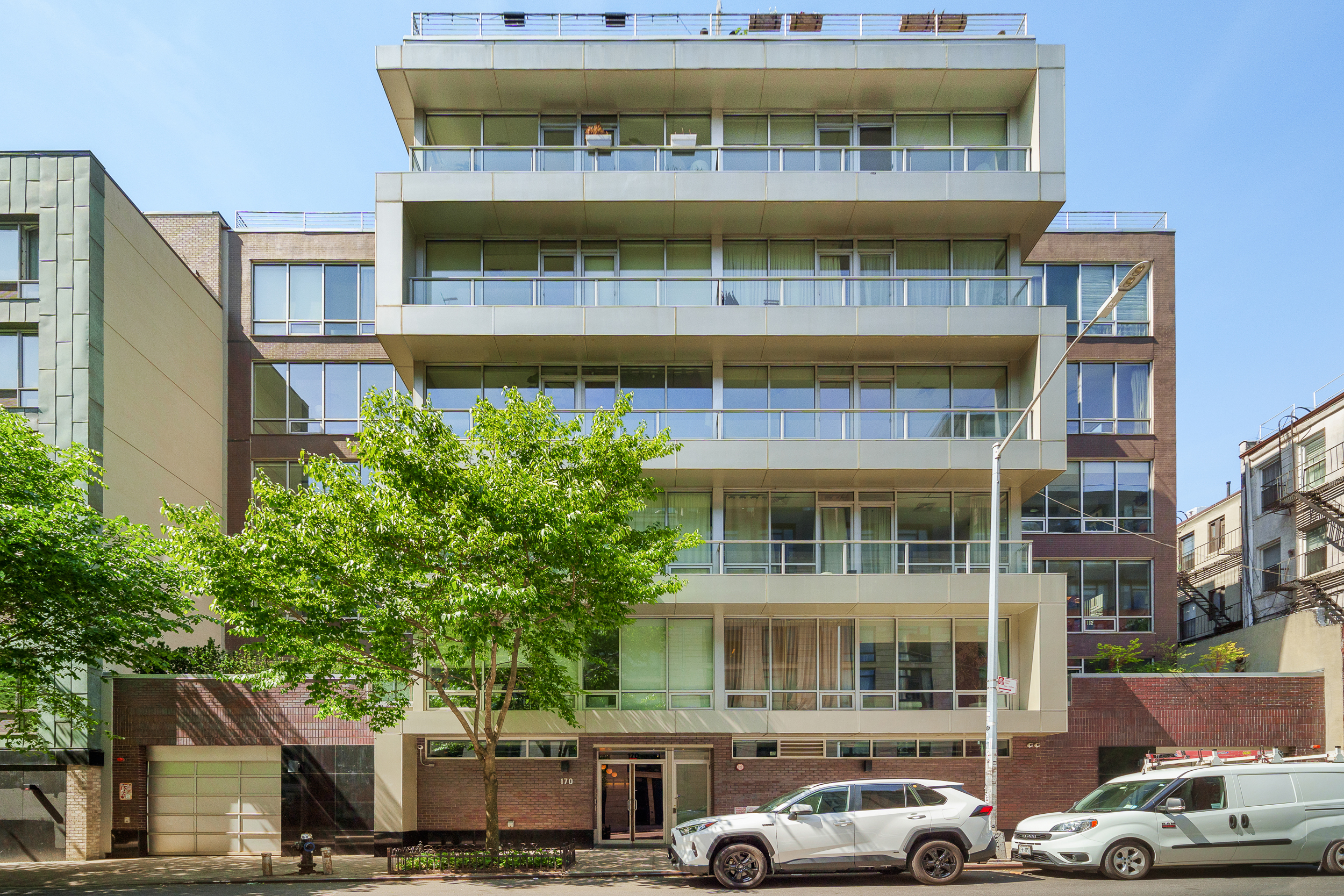 170 North 11th Street, Unit 5B Brooklyn, NY 11211 - Photo 10 of 11 a front view of a building with a yard and balcony
