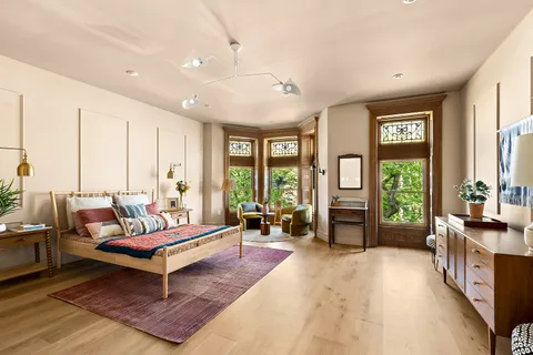 a living room with furniture and large windows
