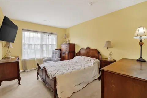 a bedroom with two beds and a flat screen tv