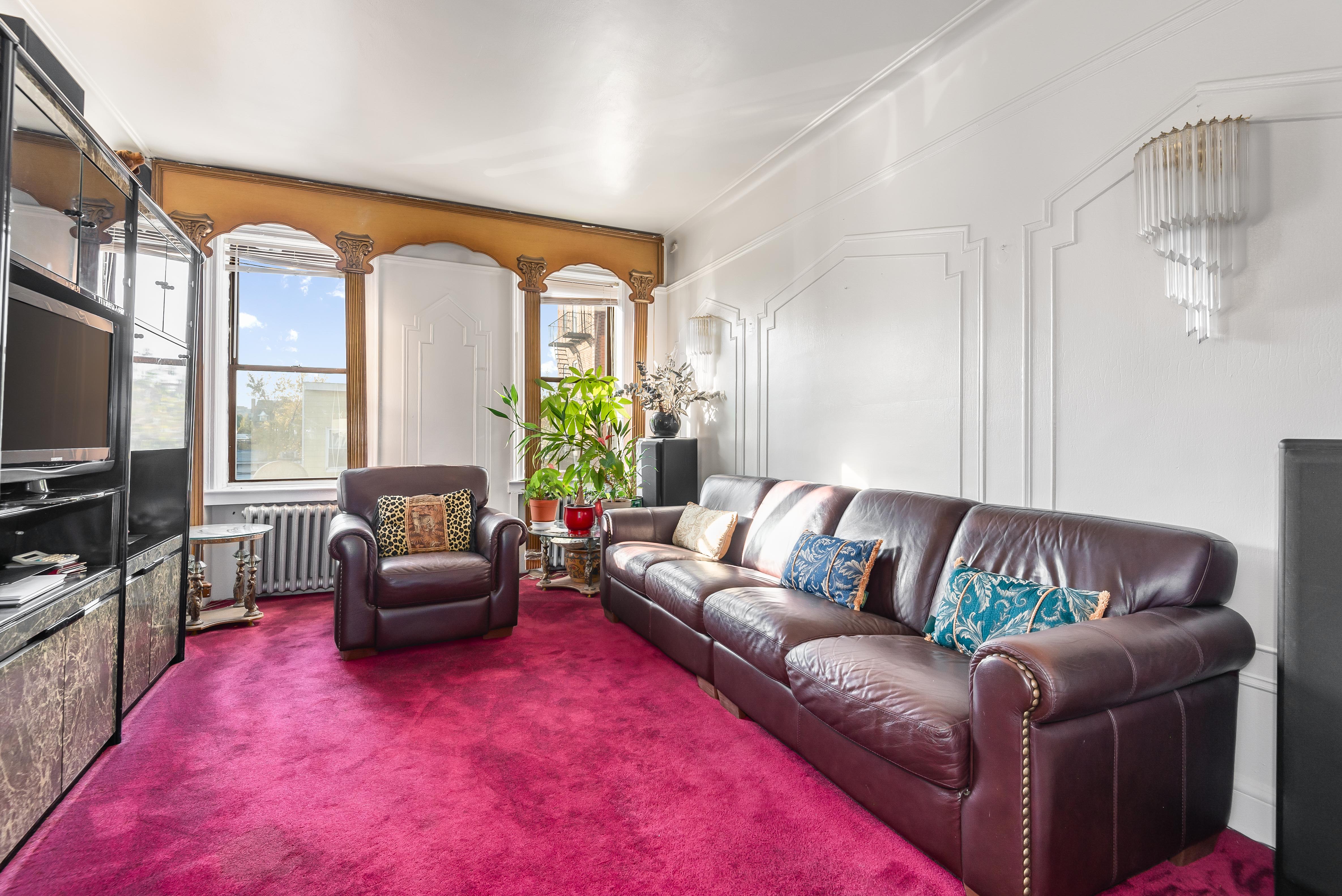 15 Lloyd Street Brooklyn, NY 11226 - Photo 12 of 18 a living room with furniture fireplace and a flat screen tv