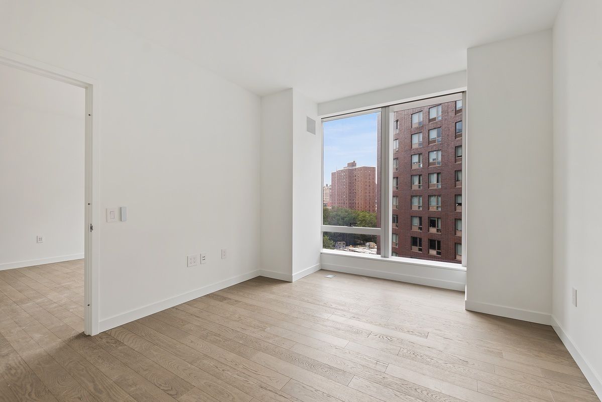 252 South Street, Unit 9J Manhattan, NY 10002 - Photo 4 of 19 a view of an empty room with glass door
