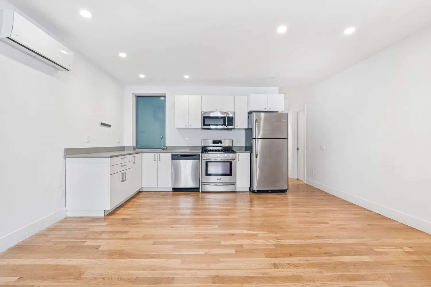 a kitchen with a refrigerator and a sink