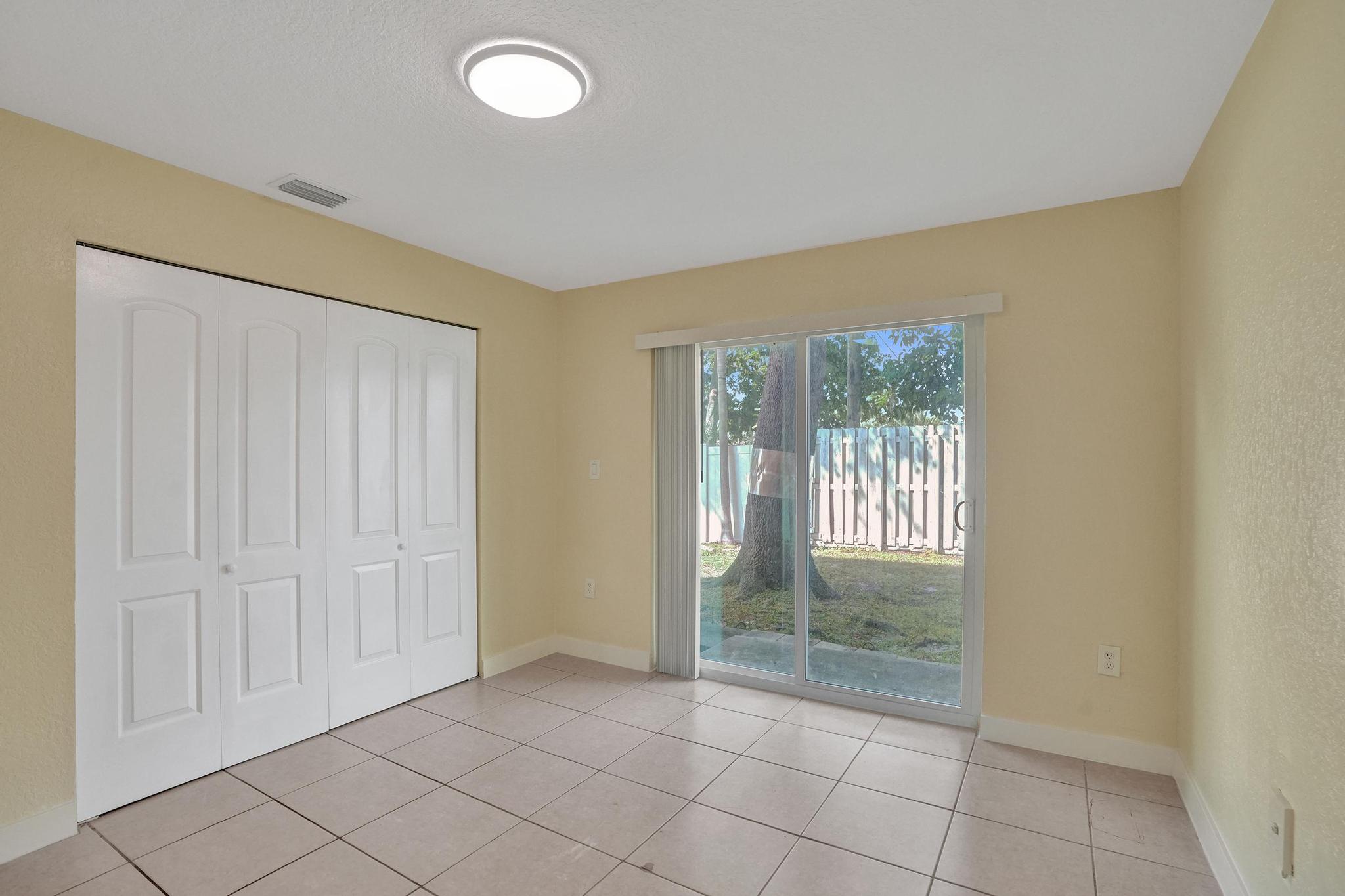 1101 Prospect Road Fort Lauderdale, FL 33309 - Photo 17 of 34 an empty room with sliding door and windows