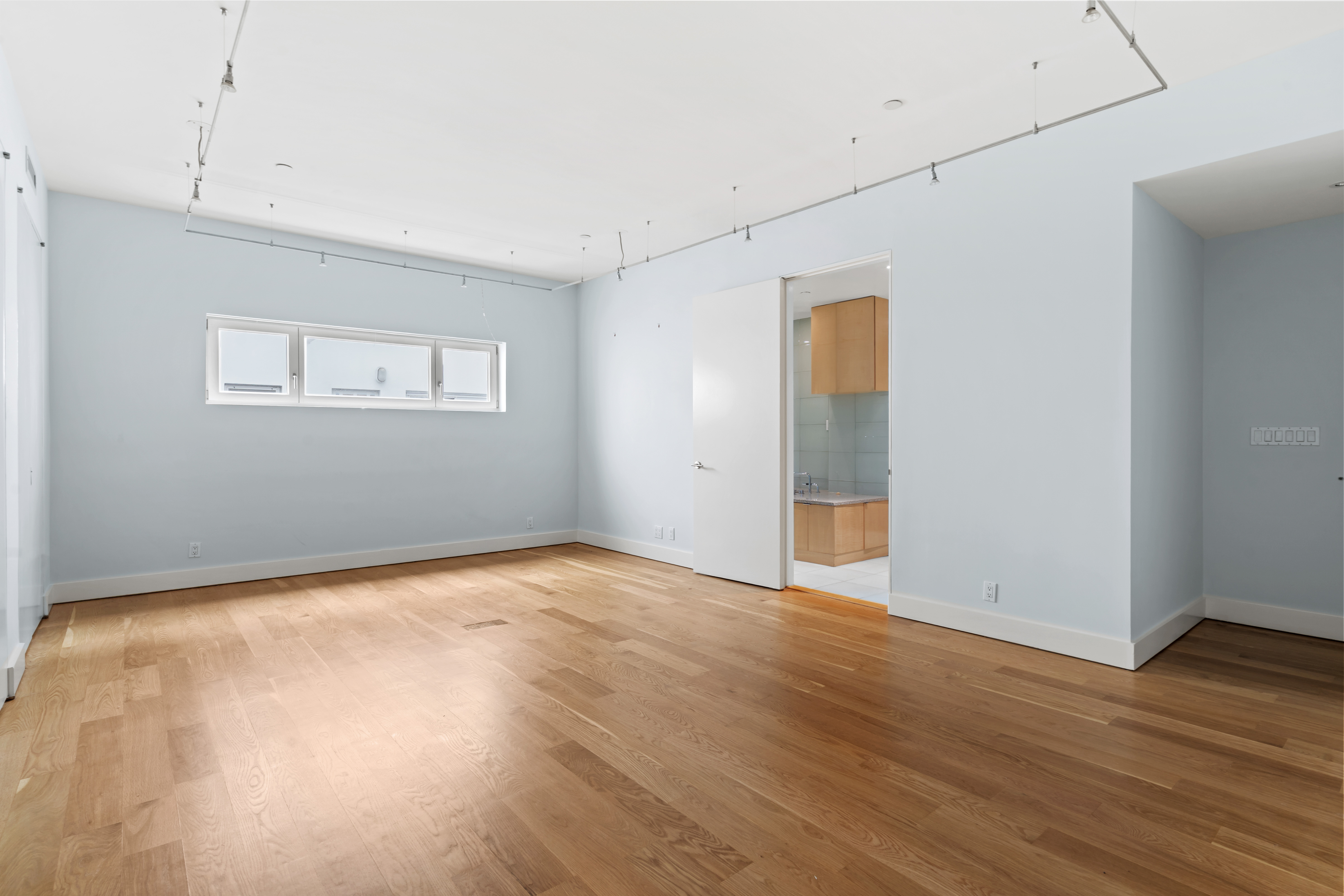 32 Laight Street, Unit 5 Manhattan, NY 10013 - Photo 17 of 31 an empty room with wooden floor and windows