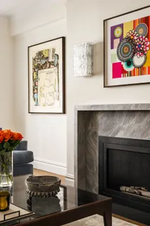 a room with a fireplace and wall paintings