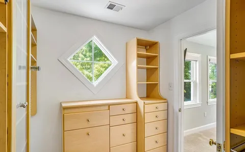 a view of closet with wooden floor