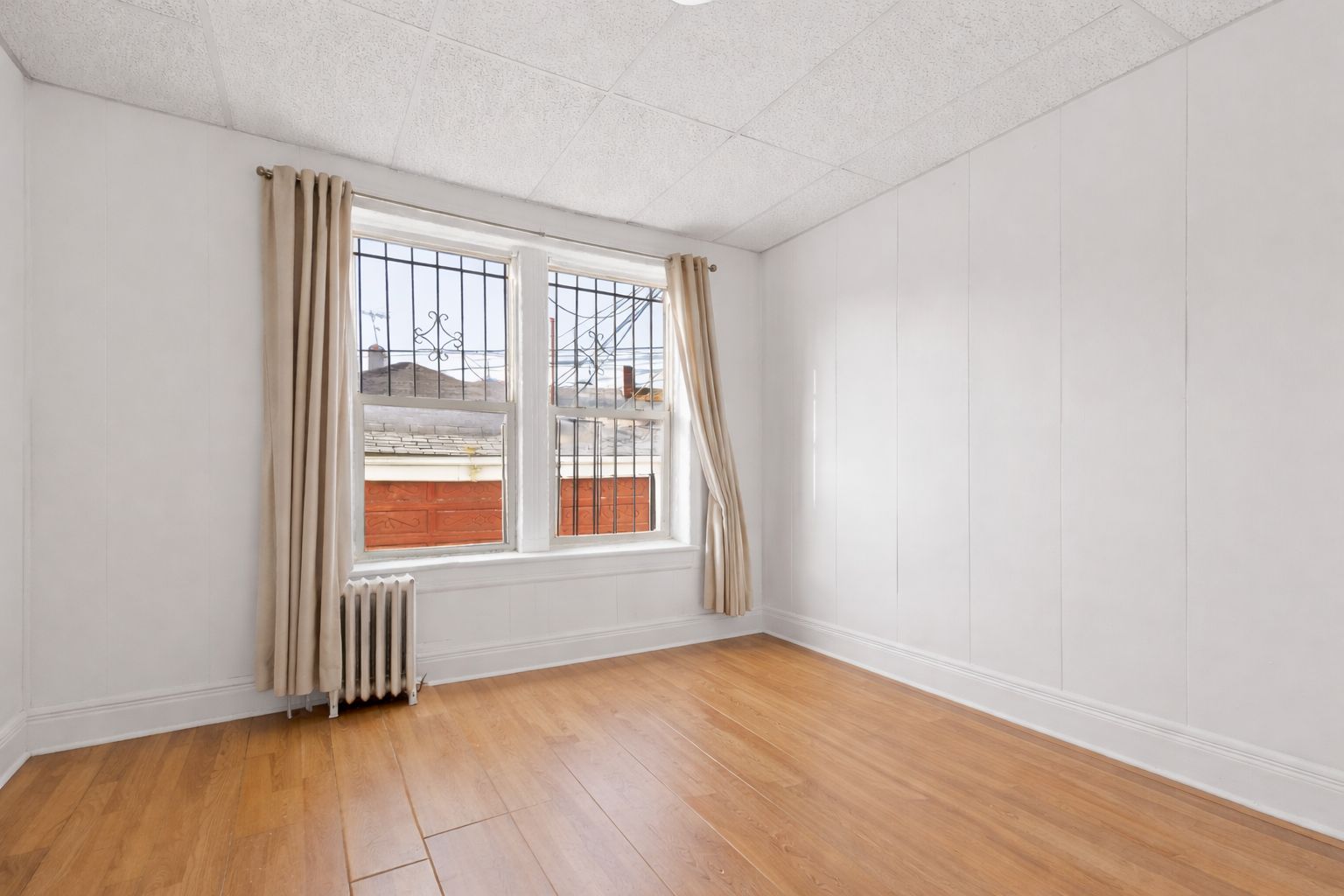 742 44th Street Brooklyn, NY 11220 - Photo 21 of 23 an empty room with wooden floor and windows