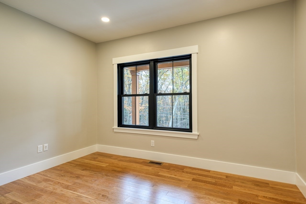 171 Randall Road Berlin, MA 01503 - Photo 17 of 41 an empty room with wooden floor and windows