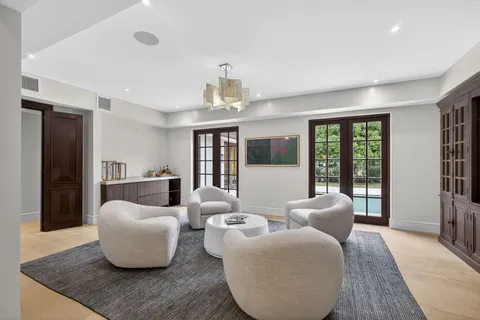 a living room with furniture and a chandelier