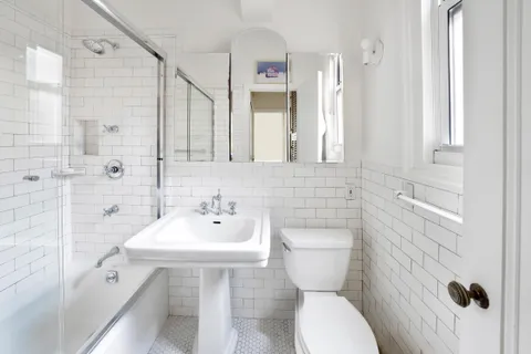 a bathroom with a toilet sink and shower