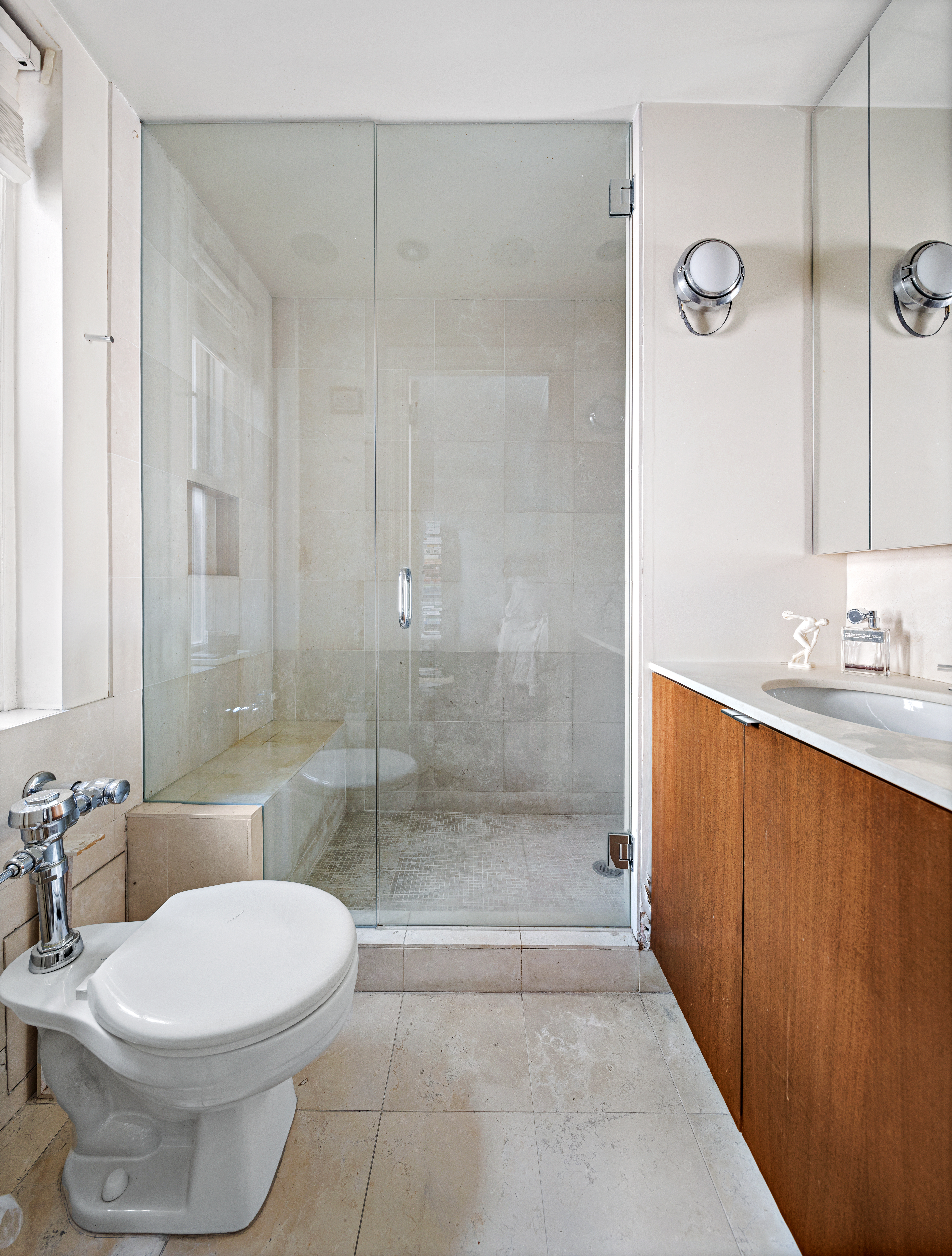 59 West 12th Street, Unit 11C Manhattan, NY 10011 - Photo 6 of 10 a bathroom with a sink a toilet and shower