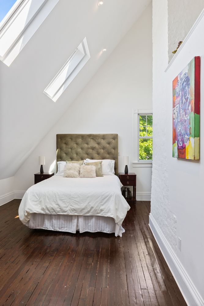 685 East 22nd Street Brooklyn, NY 11210 - Photo 28 of 43 a bedroom with a bed and wooden floor