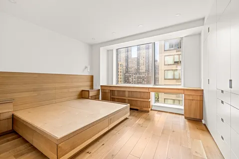 a view of a room with kitchen island stainless steel appliances a sink and living room view