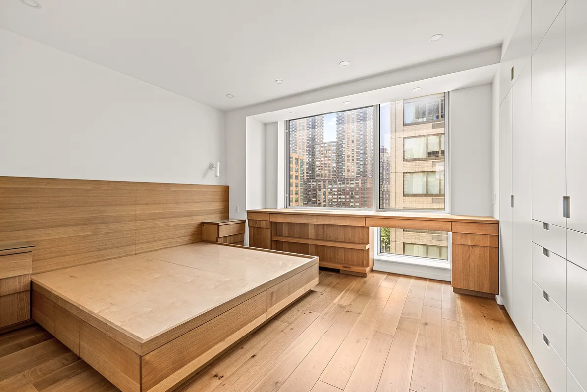 120 Riverside Boulevard, Unit 10W Manhattan, NY 10069 - Photo 6 of 13 a view of a room with kitchen island stainless steel appliances a sink and living room view