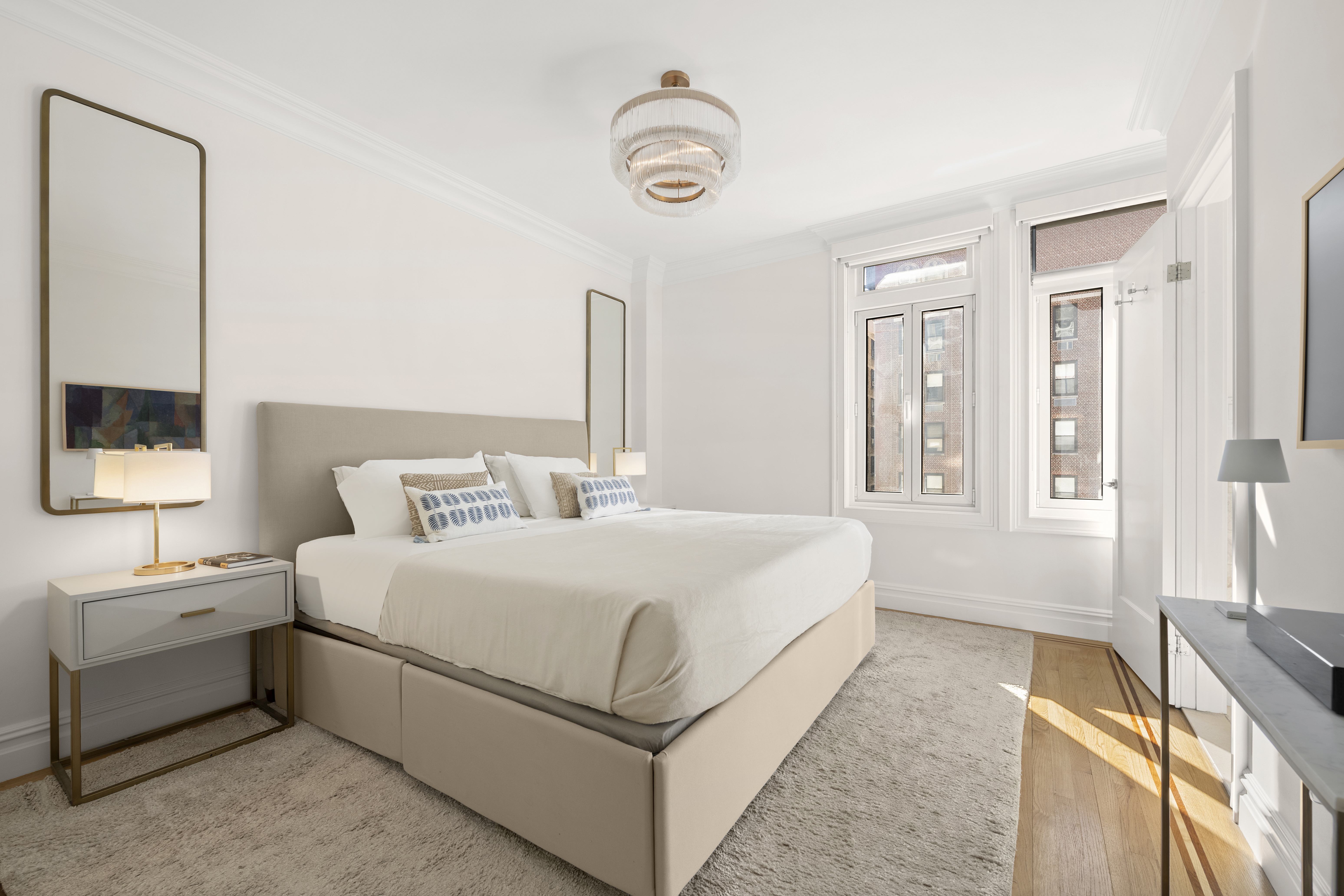 305 West 72nd Street, Unit 10A Manhattan, NY 10023 - Photo 6 of 12 a bedroom with a bed a mirror and a window