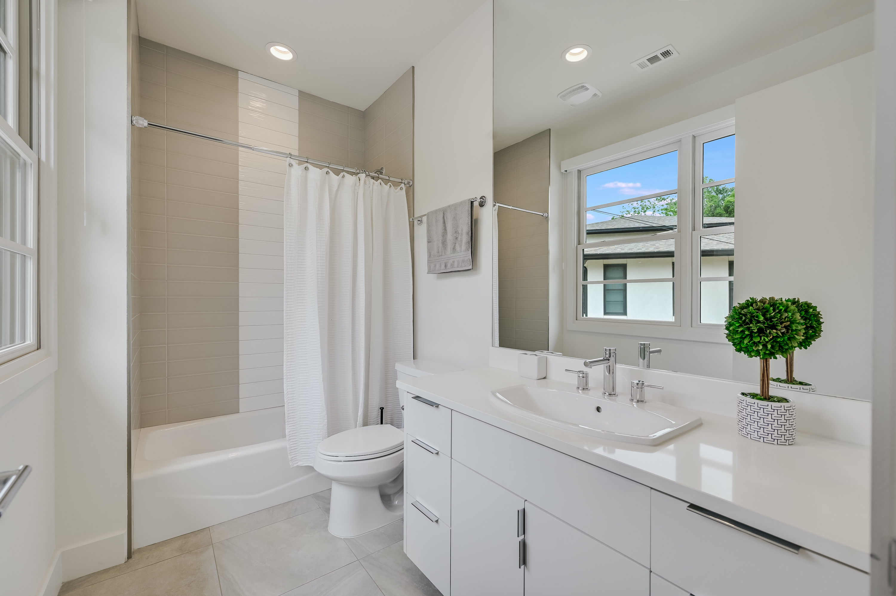 500 South 3rd Street, Unit A Austin, TX 78704 - Photo 17 of 24 a bathroom with a double vanity sink toilet and shower