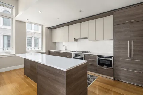 a kitchen with granite countertop a stove and a sink