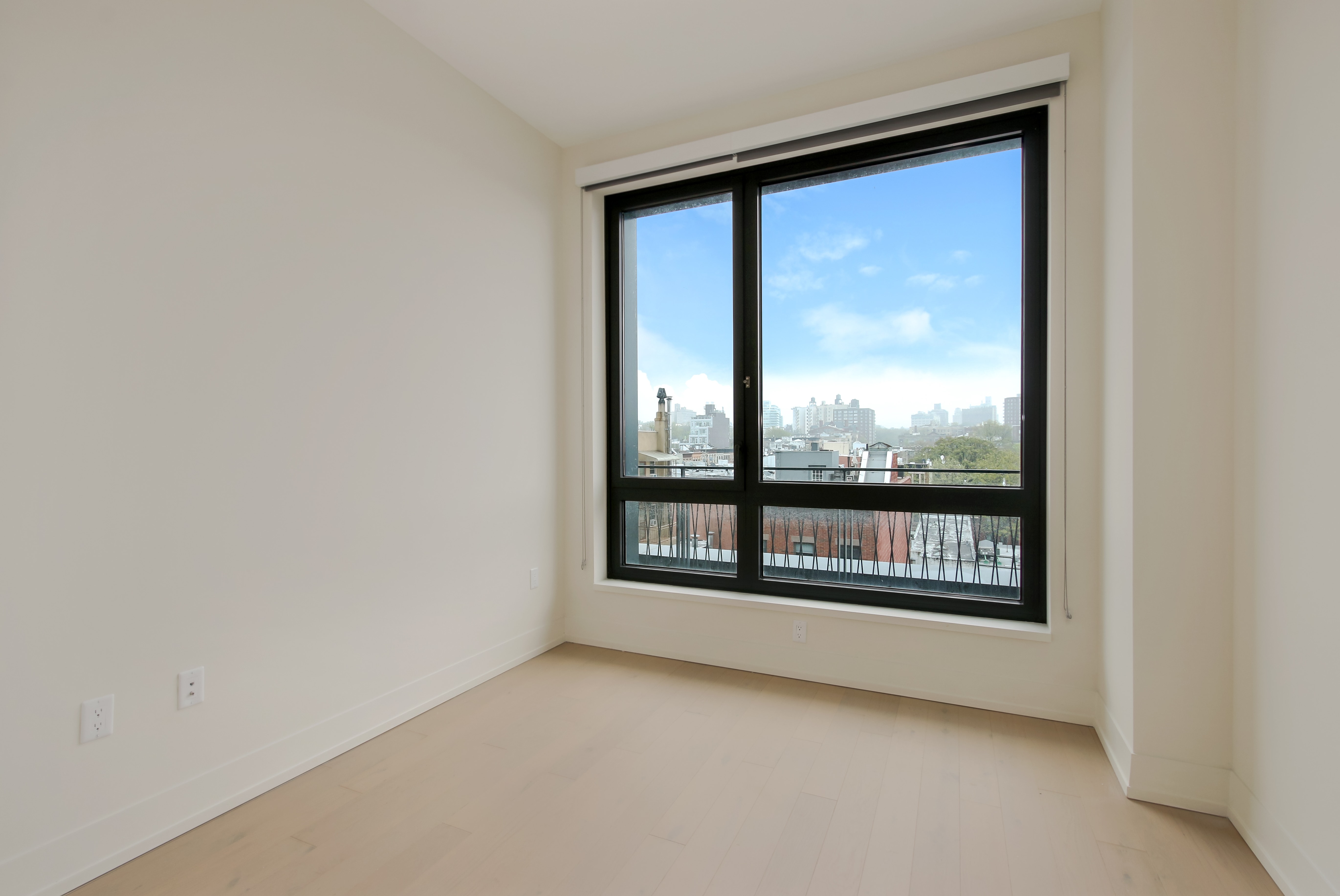 550 Vanderbilt Avenue, Unit 630 Brooklyn, NY 11238 - Photo 5 of 10 an empty room with wooden floor and windows