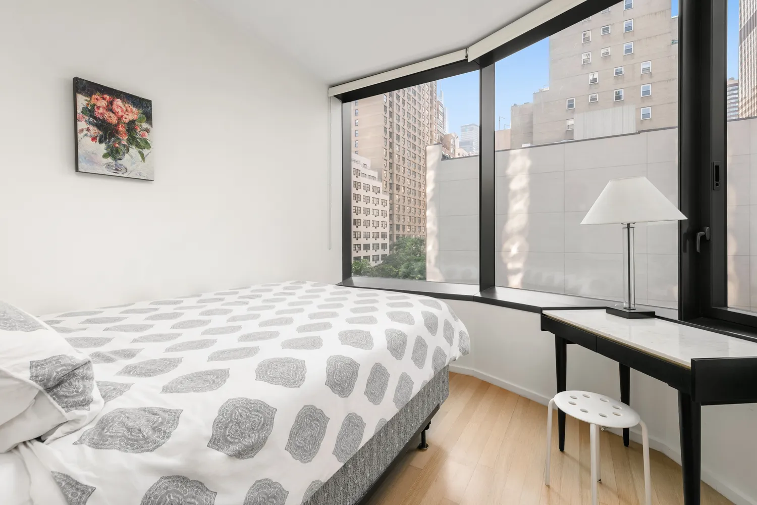 a bedroom with a bed window and a table