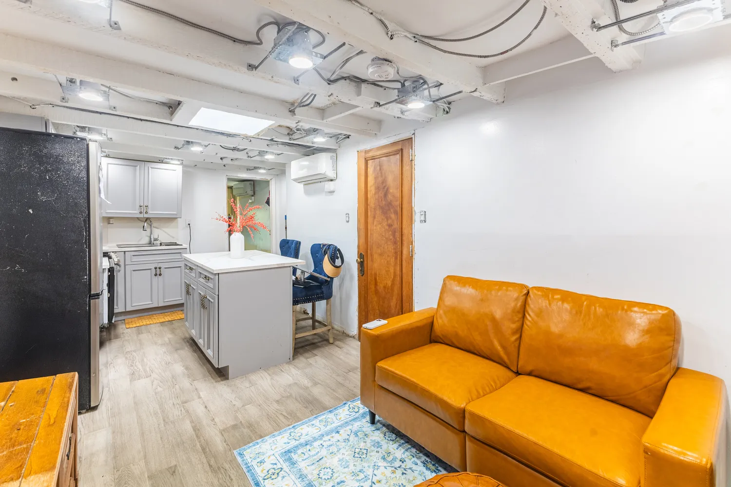 a living room with a couch and a chandelier