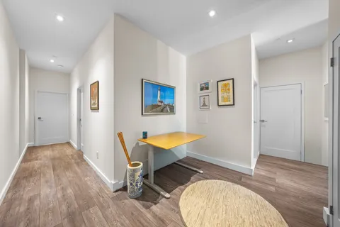 a view of a room with wooden floor pool table and windows