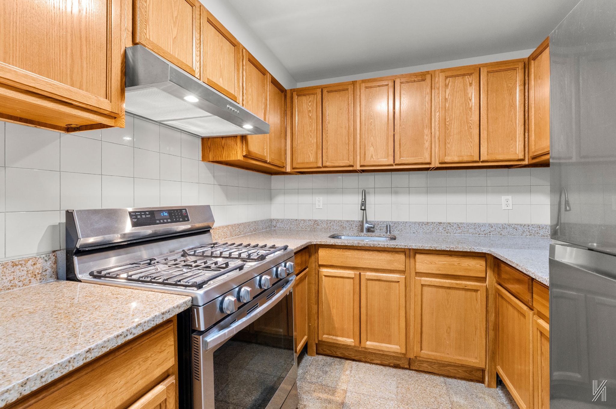 41-36 66th Street, Unit 2B Queens, NY 11377 - Photo 8 of 19 a kitchen with stainless steel appliances granite countertop a sink stove and cabinets