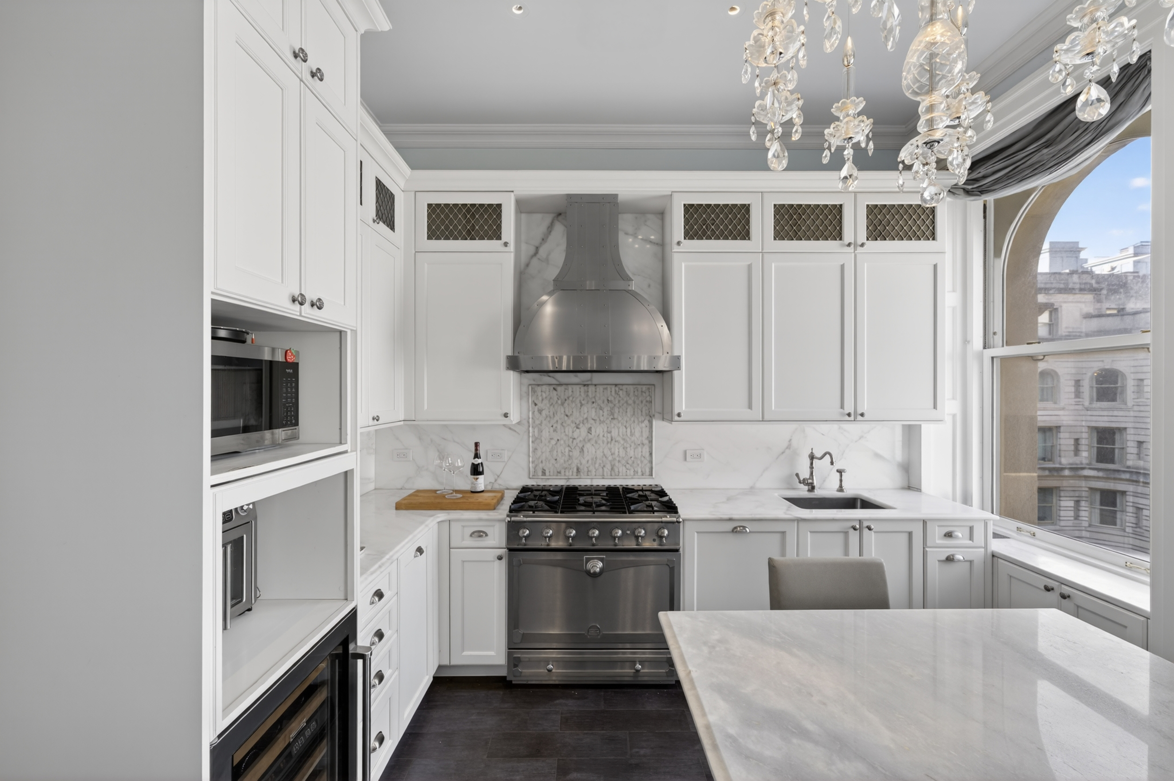 390 West End Avenue, Unit 11C Manhattan, NY 10024 - Photo 7 of 24 a kitchen with stainless steel appliances a stove and a white cabinets