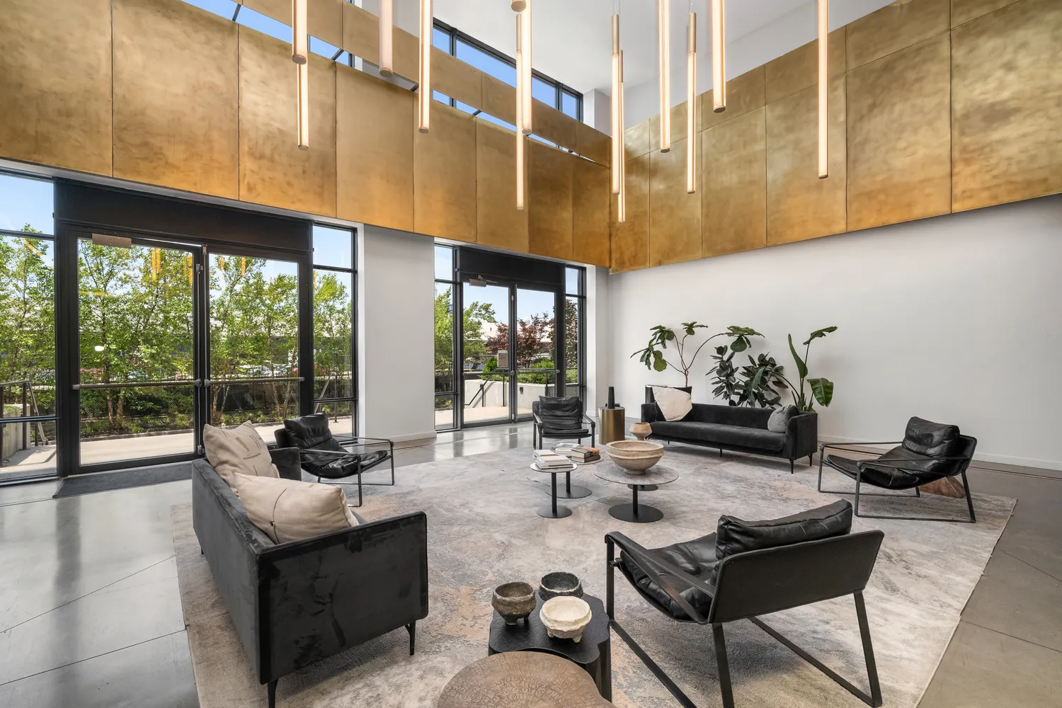 a living room with furniture and a floor to ceiling window
