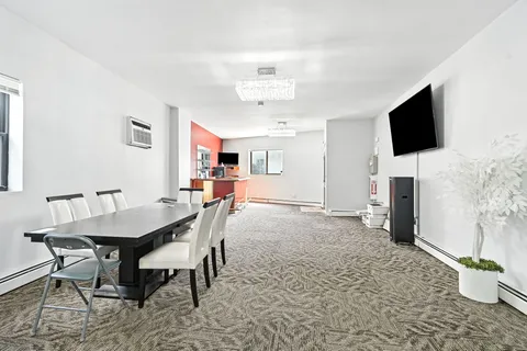 a dining room with furniture and window