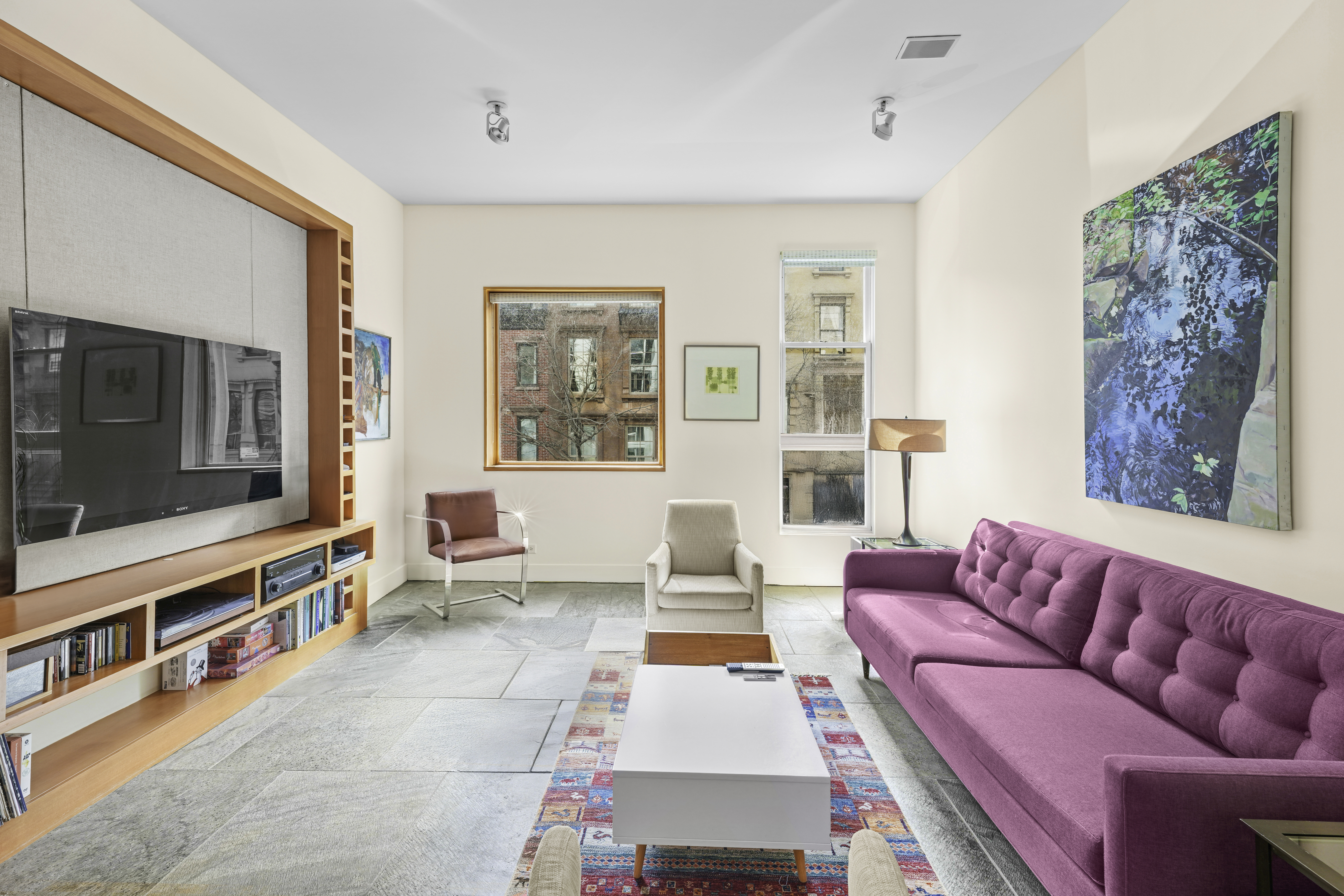 133 West 123rd Street Manhattan, NY 10027 - Photo 6 of 31 a living room with furniture and a flat screen tv