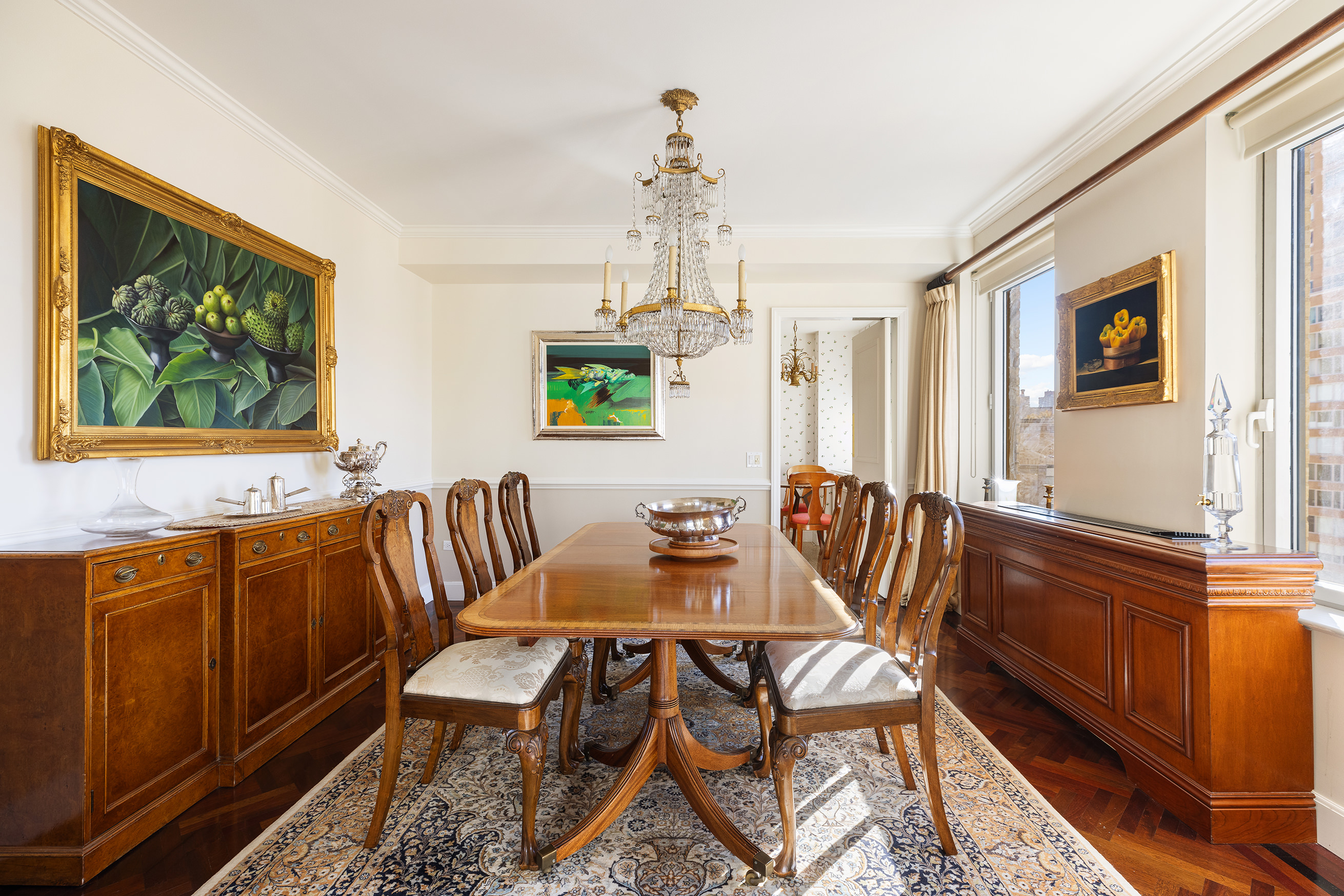 1049 5th Avenue, Unit 17A Manhattan, NY 10028 - Photo 2 of 11 a dining room with furniture a window and wooden floor