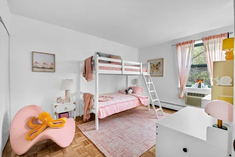 a bedroom with bed and a window