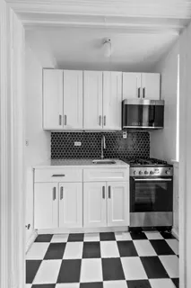 a kitchen with a stove a sink and a microwave