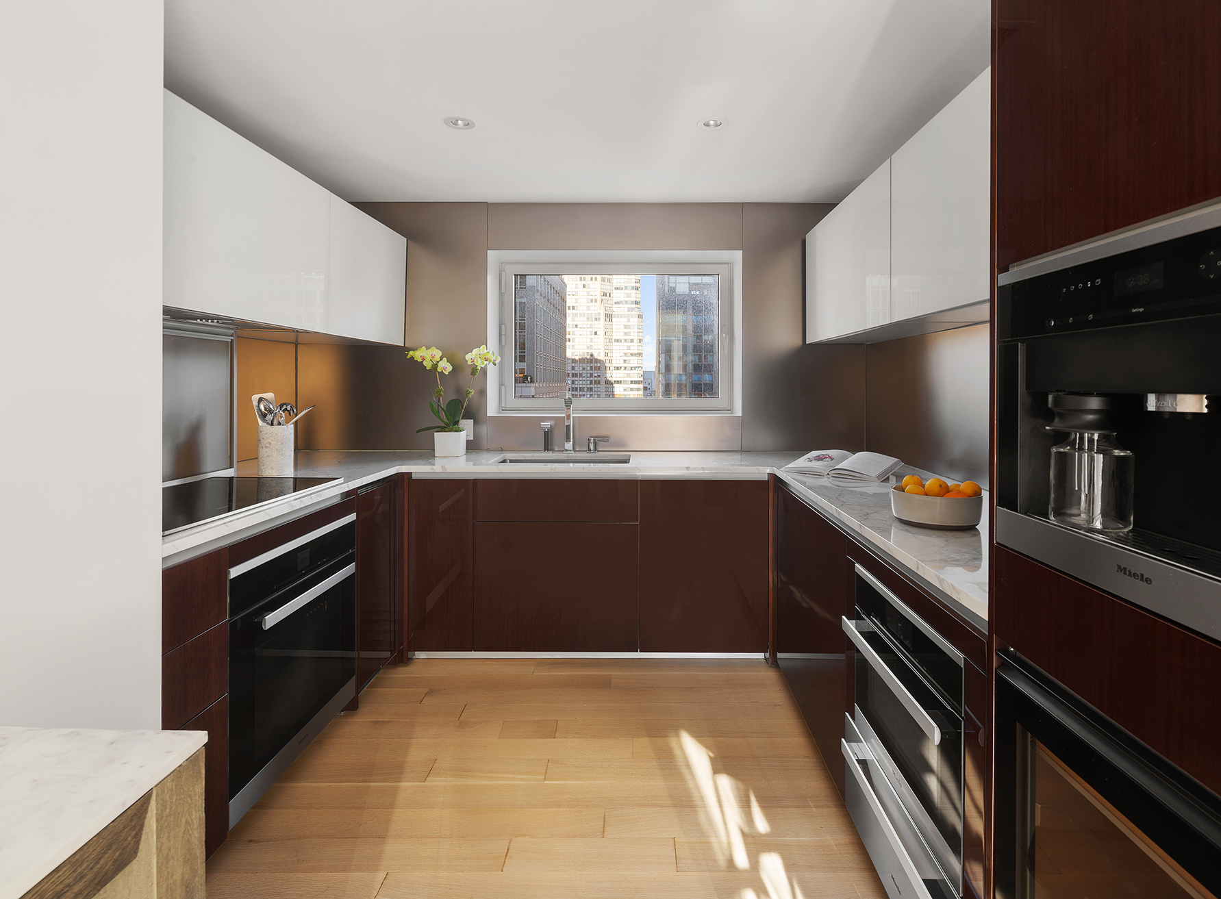 135 West 52nd Street, Unit PH3 Manhattan, NY 10019 - Photo 7 of 17 a kitchen with a sink appliances and cabinets