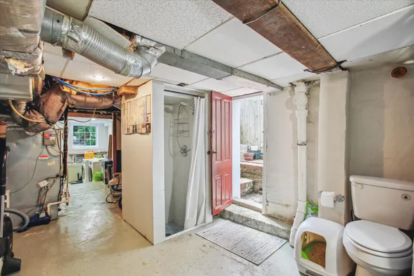 a bathroom with a toilet and a shower