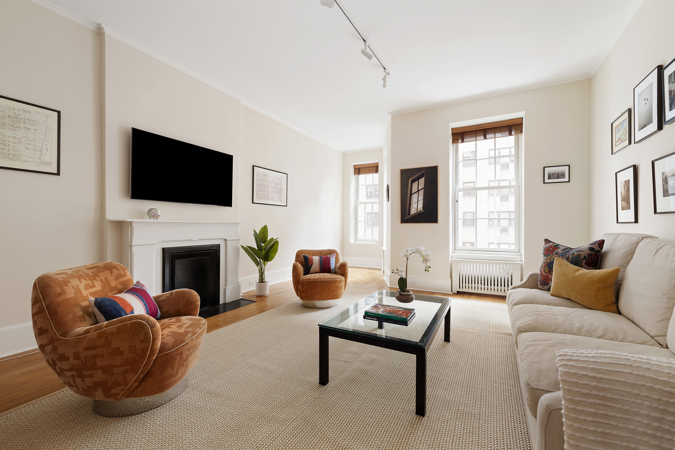 129 East 81st Street Manhattan, NY 10028 - Photo 7 of 17 a living room with furniture a fireplace and a flat screen tv