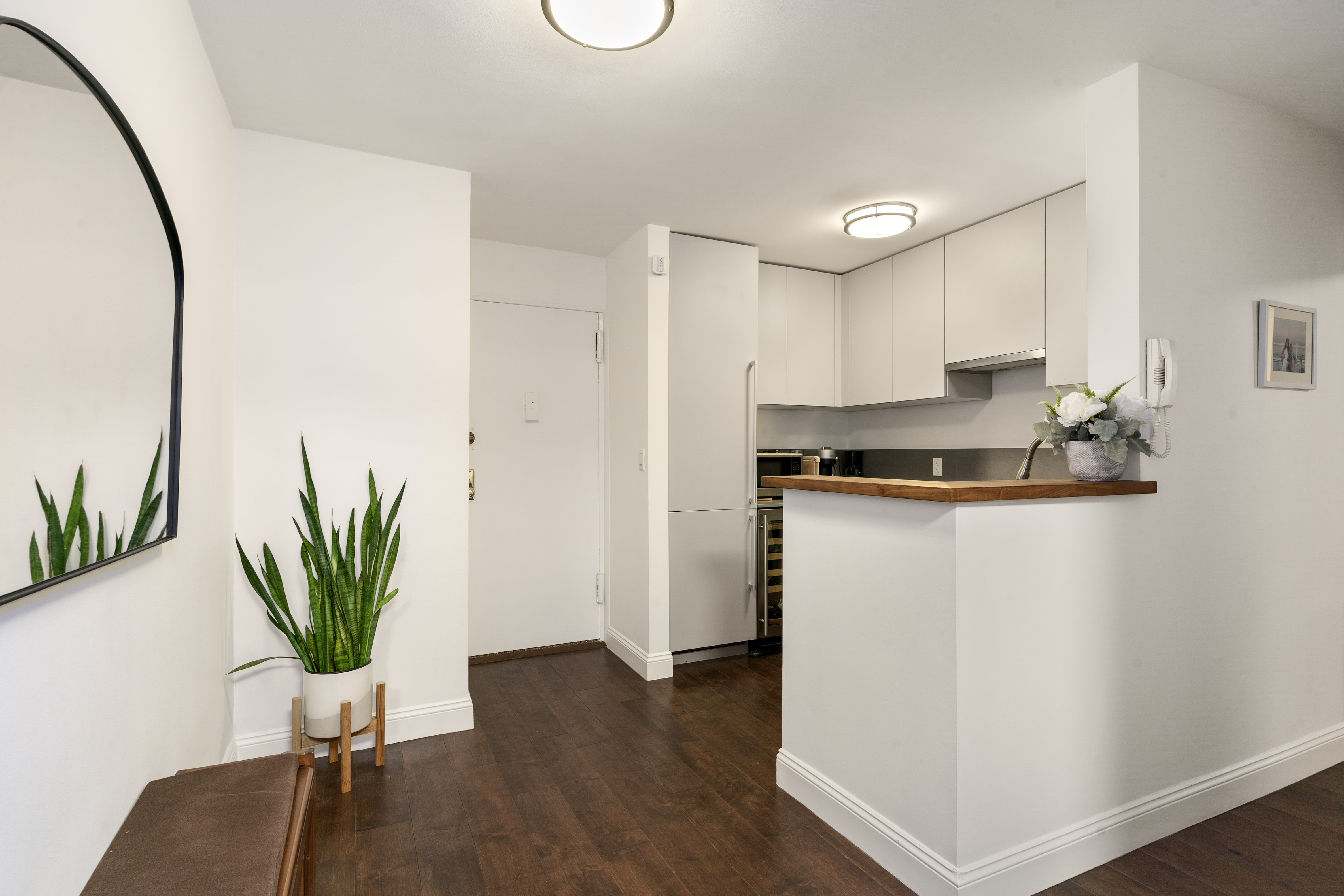 100 Bank Street, Unit 1A Manhattan, NY 10014 - Photo 2 of 6 a view of a kitchen with sink and a potted plant