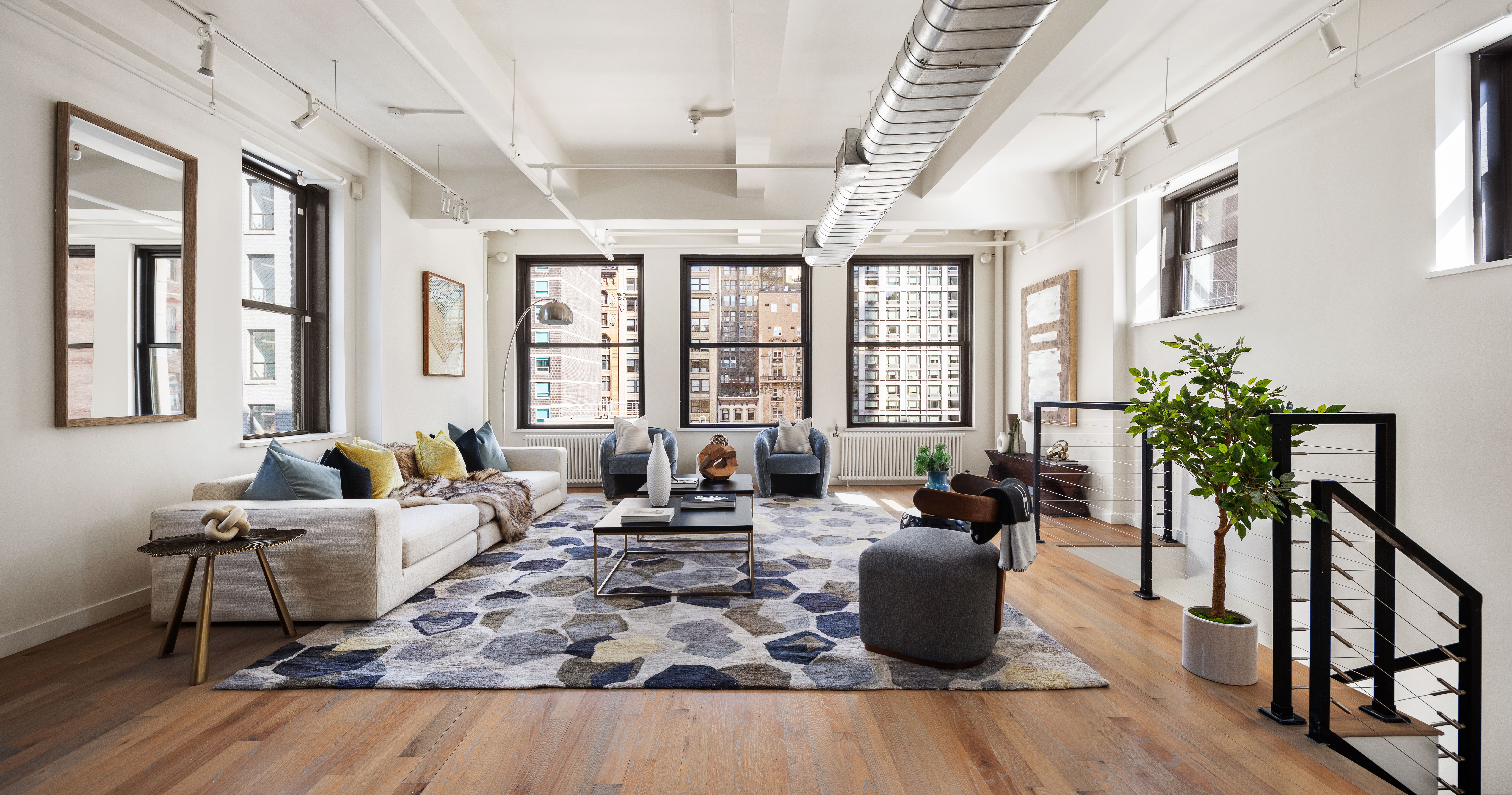 24 West 30th Street, Unit 6 Manhattan, NY 10001 - Photo 1 of 14 a living room with furniture large window and potted plants