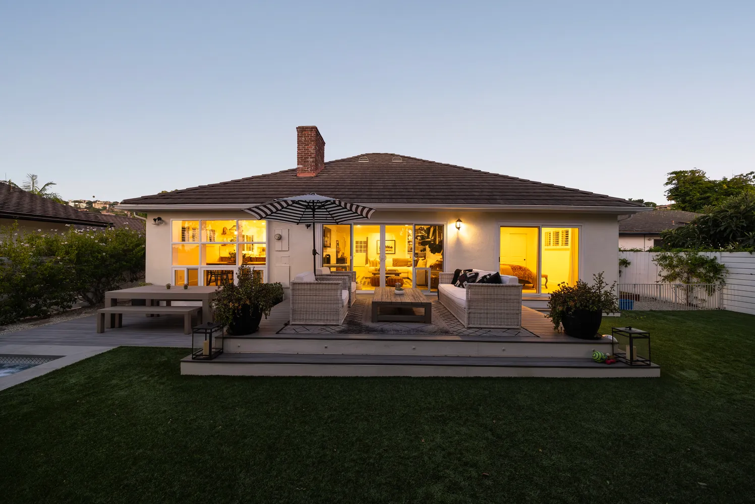 a view of patio with table and chairs under an umbrella