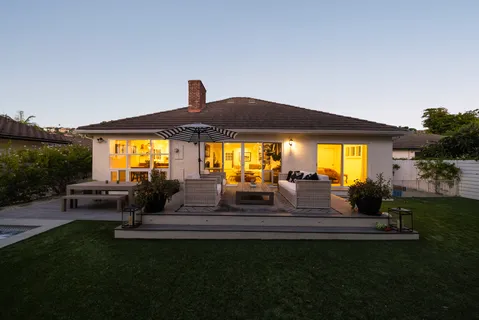 a view of patio with table and chairs under an umbrella