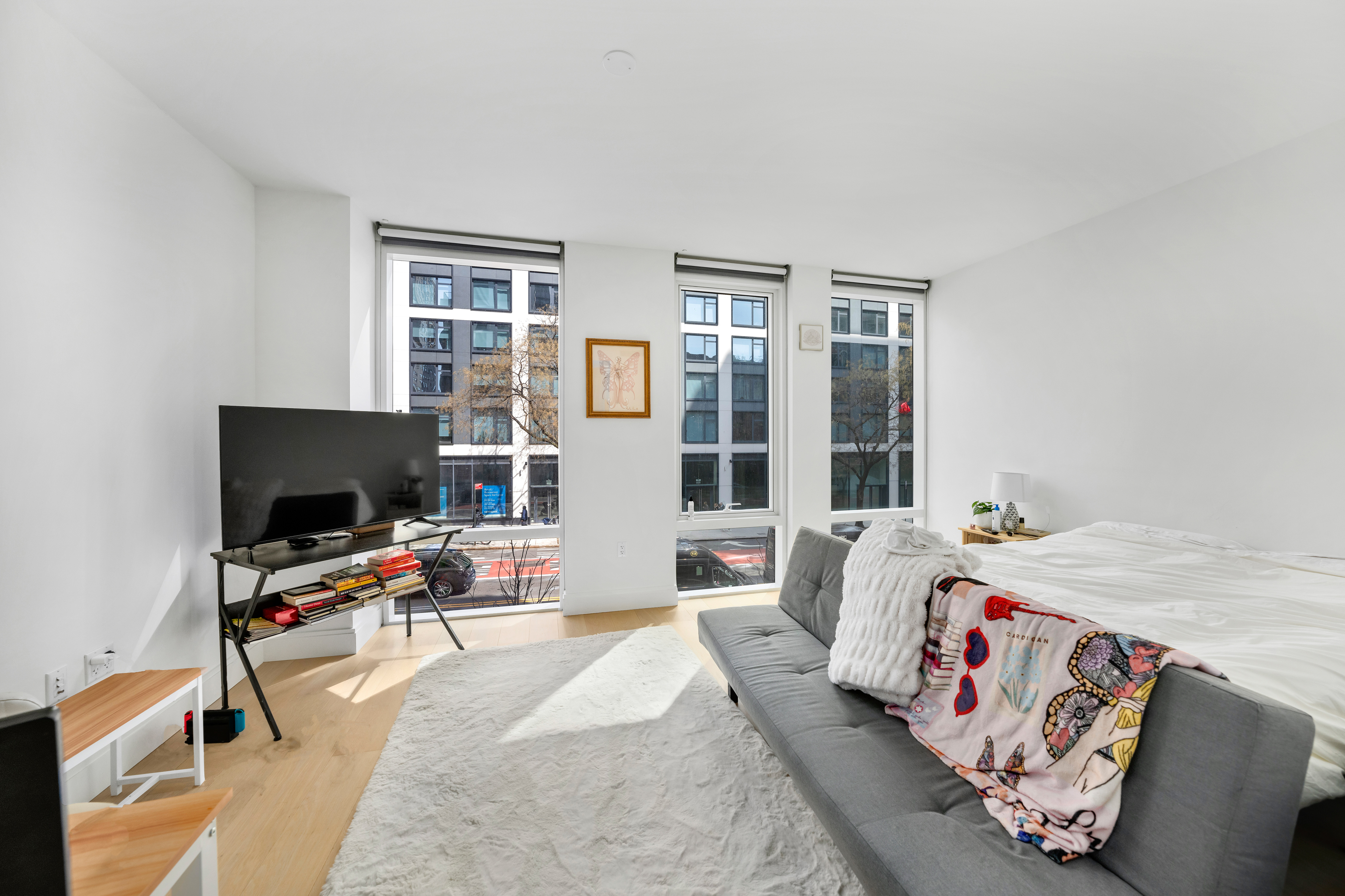 501 3rd Avenue, Unit 3C Manhattan, NY 10016 - Photo 2 of 5 a bedroom with bed and a flat screen tv