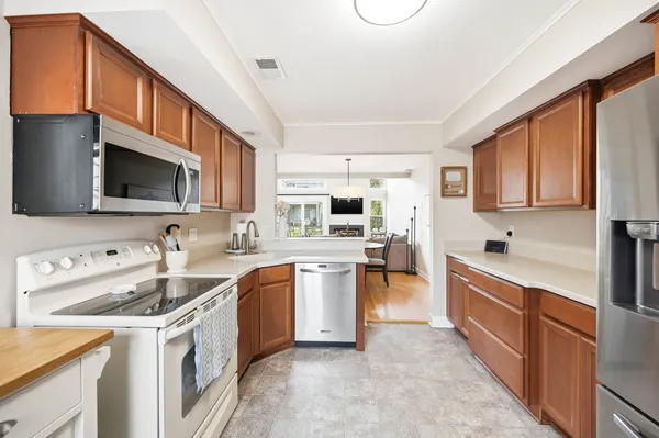 a kitchen with a sink stove top oven and refrigerator